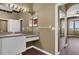 Bathroom featuring a vanity with sink, large mirror, and access to the bedroom at 1063 Mesa Verde Ct, Clermont, FL 34711