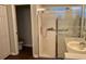 Bathroom with a glass-enclosed shower, accessible grab bars, and modern fixtures at 1063 Mesa Verde Ct, Clermont, FL 34711