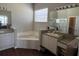 The bathroom has dual sinks, large mirrors, and a separate tub and shower for convenience at 1063 Mesa Verde Ct, Clermont, FL 34711