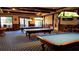 Inviting billiards room with three pool tables, complemented by unique lighting fixtures for an enjoyable gaming experience at 1063 Mesa Verde Ct, Clermont, FL 34711