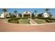 A view of the community clubhouse featuring meticulous landscaping at 1063 Mesa Verde Ct, Clermont, FL 34711