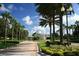 A tree-lined entrance to the Summit Greens community with lush landscaping at 1063 Mesa Verde Ct, Clermont, FL 34711
