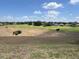A view of the community golf course with homes in the background at 1063 Mesa Verde Ct, Clermont, FL 34711