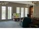 Open living area with French doors, cozy seating, and built-in shelving at 1063 Mesa Verde Ct, Clermont, FL 34711