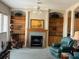 Comfortable living room boasts a fireplace, built-in shelves, and cozy seating at 1063 Mesa Verde Ct, Clermont, FL 34711