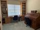 A well-lit office features wooden built-in shelving, cabinets, and two work stations at 1063 Mesa Verde Ct, Clermont, FL 34711