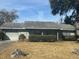 Charming single-story home featuring a well-maintained lawn, mature landscaping, and an attached garage at 1344 Cr 437, Lake Panasoffkee, FL 33538