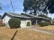 Charming single-story home featuring a well-maintained lawn, mature landscaping, and an attached garage at 1344 Cr 437, Lake Panasoffkee, FL 33538