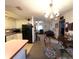Cozy living room featuring carpeted floors, a chandelier, and open access to the kitchen at 1344 Cr 437, Lake Panasoffkee, FL 33538