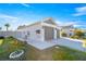 The exterior of the home displays a charming two-car garage, a well-maintained lawn, and colorful flowerbeds at 1658 Galloway Dr, The Villages, FL 32163