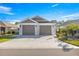Charming single-story home showcasing a two-car garage, inviting walkway, and manicured landscaping at 1658 Galloway Dr, The Villages, FL 32163