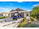 Charming single-story home showcasing a two-car garage, inviting walkway, manicured landscaping, and golf cart at 1658 Galloway Dr, The Villages, FL 32163