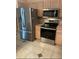 A stainless steel refrigerator and oven are visible in this kitchen at 1201 De La Fuente Ct, The Villages, FL 32162