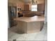 This kitchen features an island, tile flooring and stainless steel appliances at 1201 De La Fuente Ct, The Villages, FL 32162