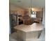 Bright kitchen features an island, stainless steel appliances, and tile flooring at 1201 De La Fuente Ct, The Villages, FL 32162