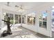 Sunroom features walls of windows and a ceiling fan at 1201 De La Fuente Ct, The Villages, FL 32162