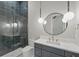 Modern bathroom featuring a glass shower, stylish vanity, and unique hanging lights, all in a neutral color palette at 16914 Vinci Way, Bella Collina, FL 34756