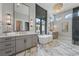 Luxurious bathroom featuring marble floors, soaking tub, double vanities, and a glass-enclosed shower at 16914 Vinci Way, Bella Collina, FL 34756