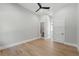 Bright bedroom features wood floors, neutral walls, a modern ceiling fan, and access to a bathroom at 16914 Vinci Way, Bella Collina, FL 34756