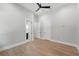 Bright bedroom features wood floors, neutral walls, a modern ceiling fan, and access to a bathroom at 16914 Vinci Way, Bella Collina, FL 34756