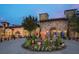 Gated community entrance with a grand stone building and fountain at 16914 Vinci Way, Bella Collina, FL 34756