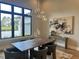 Sophisticated dining room showcasing a modern chandelier, dark wood table, and a large window overlooking the outdoors at 16914 Vinci Way, Bella Collina, FL 34756