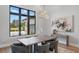 Bright dining room with a view of the outdoors, showcasing a modern chandelier and stylish furniture at 16914 Vinci Way, Bella Collina, FL 34756