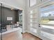 Beautiful foyer view into the office, showcasing the glass door and hardwood floors with an abundance of natural light at 16914 Vinci Way, Bella Collina, FL 34756