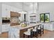 Modern kitchen with a large marble island, stainless steel appliances, and contemporary pendant lighting at 16914 Vinci Way, Bella Collina, FL 34756