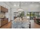 Well-appointed kitchen with a marble island, designer lighting, and premium appliances at 16914 Vinci Way, Bella Collina, FL 34756