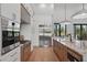 Contemporary kitchen boasting stainless steel appliances, marble countertops, and custom cabinets at 16914 Vinci Way, Bella Collina, FL 34756