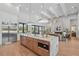 Open-concept kitchen with a large island, stainless steel appliances, and modern finishes at 16914 Vinci Way, Bella Collina, FL 34756