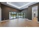 Open living room with floor to ceiling windows overlooking pool and backyard at 16914 Vinci Way, Bella Collina, FL 34756