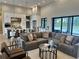 Bright living room open to modern kitchen, outdoor views and access to the pool at 16914 Vinci Way, Bella Collina, FL 34756