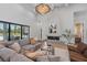 Elegant living room with a modern fireplace, comfortable seating, and large sliding glass doors to the patio at 16914 Vinci Way, Bella Collina, FL 34756