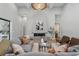 Comfortable living room with a large fireplace and modern decor, creating a welcoming atmosphere for relaxation at 16914 Vinci Way, Bella Collina, FL 34756