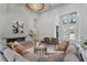 Bright living room features a contemporary fireplace, plush seating, and access to the front entrance at 16914 Vinci Way, Bella Collina, FL 34756