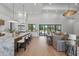 Open-concept living space showcases a modern kitchen, cozy living room, and access to the outdoor pool area at 16914 Vinci Way, Bella Collina, FL 34756