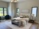 Serene main bedroom featuring hardwood floors, minimalist decor and lots of natural light at 16914 Vinci Way, Bella Collina, FL 34756