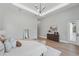 Bright main bedroom featuring tray ceiling, light hardwood floors, and a decorative light fixture at 16914 Vinci Way, Bella Collina, FL 34756