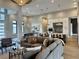 Spacious open concept layout with a living room, dining area, and kitchen with bar stool seating at 16914 Vinci Way, Bella Collina, FL 34756