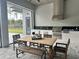Outdoor kitchen and dining area with built-in grill and patio table at 16914 Vinci Way, Bella Collina, FL 34756