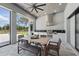 Outdoor kitchen featuring stainless steel appliances, grill, and dining table for entertaining guests at 16914 Vinci Way, Bella Collina, FL 34756