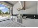 Close up of outdoor kitchen featuring stainless steel appliances, grill, and sink at 16914 Vinci Way, Bella Collina, FL 34756