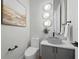 Contemporary powder room with textured wall, modern vanity, vessel sink, and stylish lighting at 16914 Vinci Way, Bella Collina, FL 34756