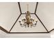 Elegant chandelier with intricate detailing, enhancing the home's interior at 1974 Wallingford Loop, Mount Dora, FL 32757