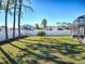 Spacious backyard featuring a privacy fence, screened patio, lush lawn, and mature trees at 2150 White Dahlia Dr, Apopka, FL 32712