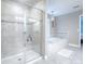 The bathroom boasts a glass shower and a soaking tub with modern lighting and fixtures at 2150 White Dahlia Dr, Apopka, FL 32712