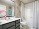 This bathroom is decorated with a mirror, silver accents, a bathtub and a shower at 2150 White Dahlia Dr, Apopka, FL 32712