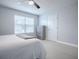 Bedroom with a ceiling fan, window, dresser, and a neutral color scheme, creating a calming atmosphere at 2150 White Dahlia Dr, Apopka, FL 32712